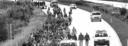 A crowd of refugees walking on the road